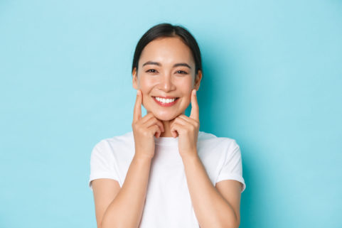 Close-up,Of,Beautiful,Asian,Girl,Looking,Pleased,,Smiling,White,Teeth,
